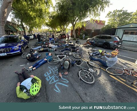 Supporters of the proposal for a bike lane on Hopkins Street are holding a “die-in”