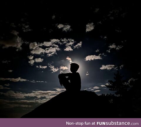 Boy on rock in moonlight