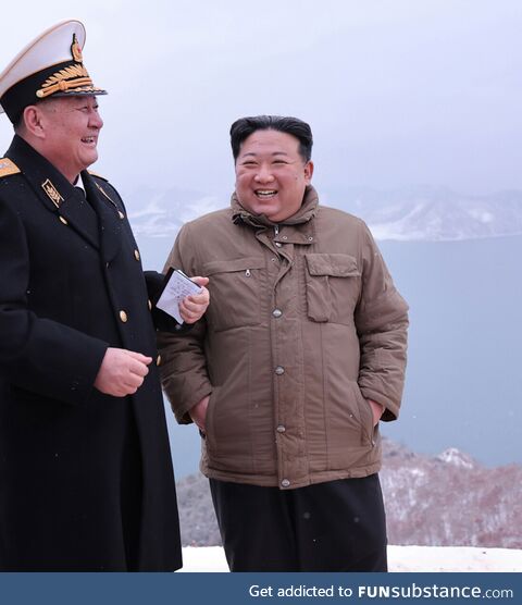 Kim Jong Un observing a nuclear missile test launch from a submarine