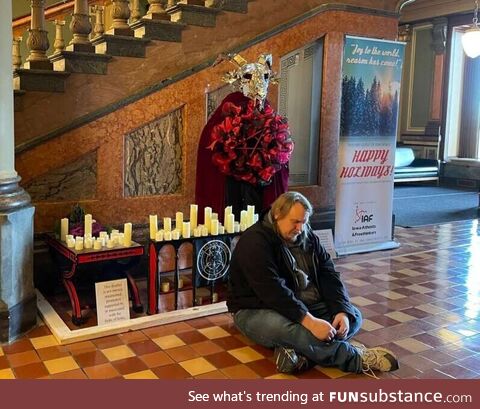 A Baphomet was installed in the Iowa Capitol. A man thinking it represents Satan, pray in