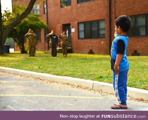 An Afghan child salutes during the US national anthem Sept. 14, 2021 at Joint Base McGuire