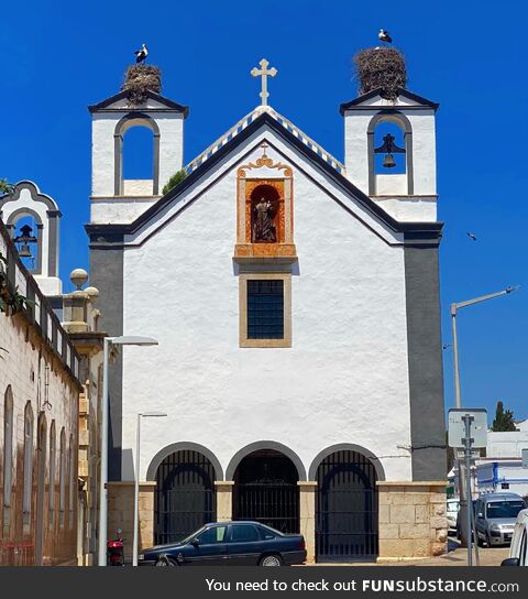 Two storks’ nests on a church in Faro, Portugal