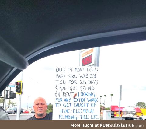 A father holding a sign