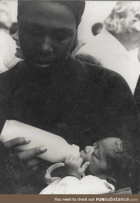 Afeni Shakur feeding a baby 2Pac at a Black Panther rally