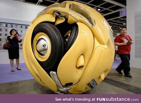 A Volkswagen Beetle compressed into a ball. From artist Ichwan Noor