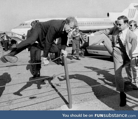 Jimmy Carter showing Secret Service how to properly jump over a fence