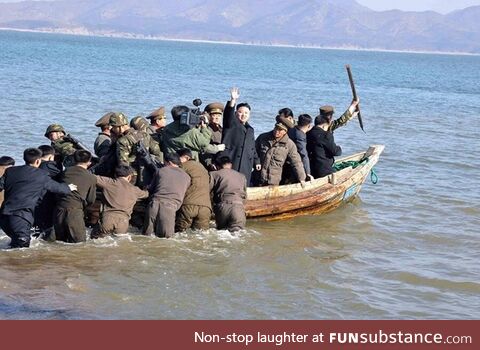 North Korean leader Kim Jong-Un waves from one of his naval ships