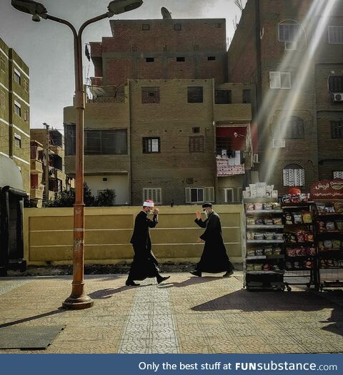 Egyptian muslim and Christian priests salute each other in the street. By Hassan Gamal