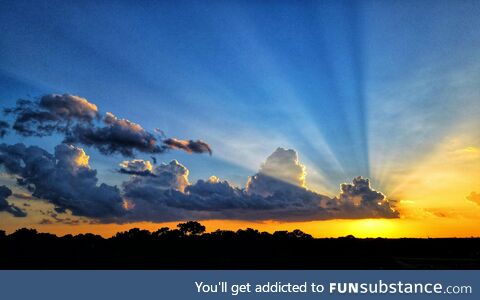 Cloud creating rays with a setting sun, houston