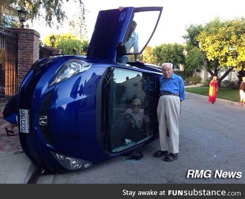 Elderly couple posing for photo after their car flipped