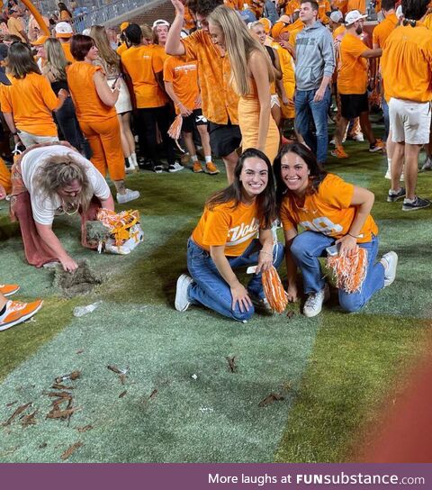 A Tennessee fan taking a souvenir after winning over Alabama