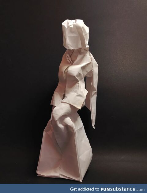 Origami seated woman, folded from a square of paper