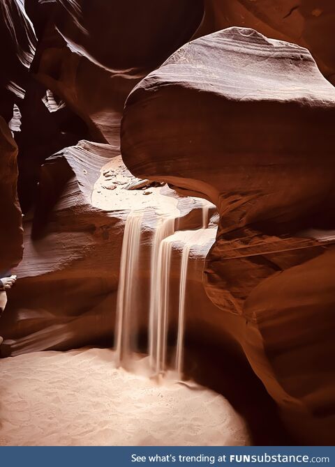 Caught this photo of a sand waterfall (sandfall?) induced by the guide at Antelope