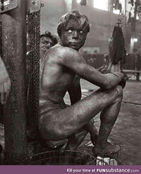 Coal miner waiting to get in the communal shower at the end of a shift, Germany, 1958