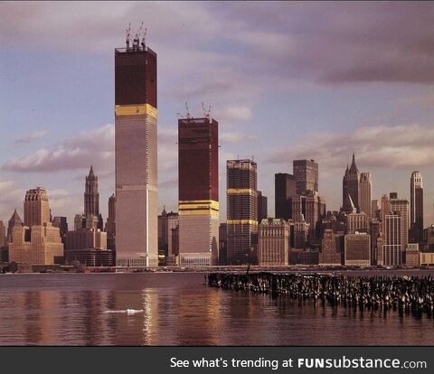 The original World Trade Center under construction, as viewed from Jersey City shoreline