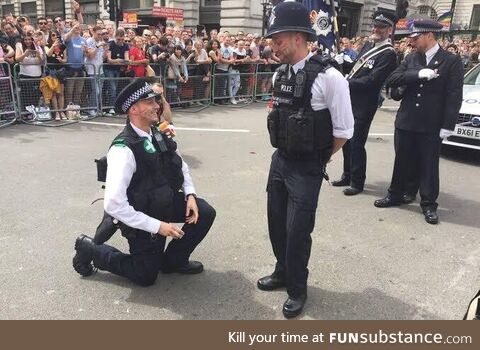 Police officer proposing to his colleague during London pride walk