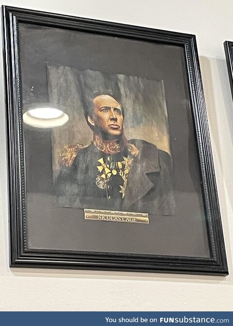 An Asian restaurant in NYC has a picture of Nic Cage in some sort of European Military