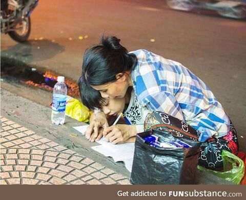 Poor Mother teaches her Son how to write letters (A street in Vietnam)