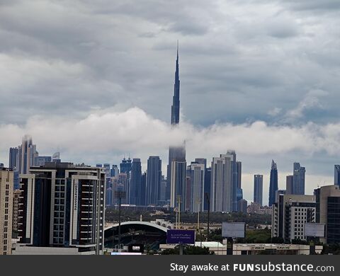 Burj Khalifa being bisected by clouds after dubai receives its worst rains in years
