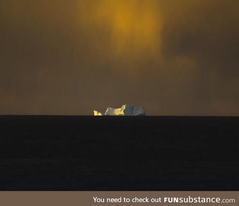 Took a sunset shot of this huge iceberg far away in the distant in the Atlantic Ocean