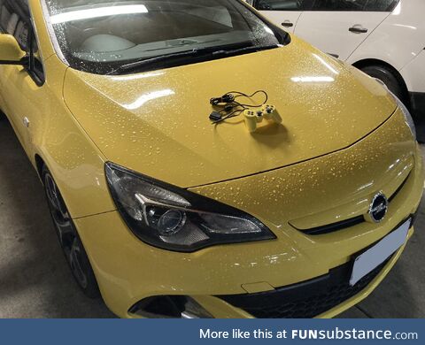 European Automobile Yellow PS2 Controller on a Yellow Car