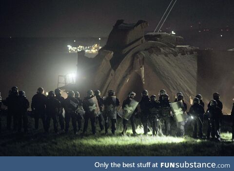 German police protect an opencast mine of a company that destroys a village in order to