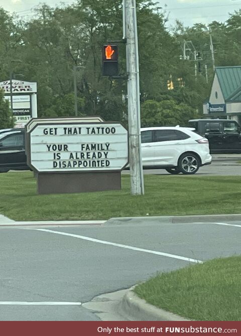 Sign outside a local tattoo parlor in Michigan