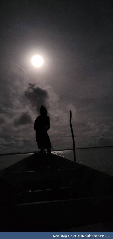 Local guide leading us on a wooden boat in the Atlantic Ocean to see leatherback turtles