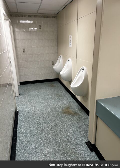 Worn out marks on the floor show the rule of thumb for using a urinal
