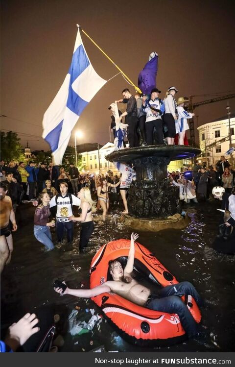 Finnish hockey fans at the Havis Amanda fountain in Helsinki shortly after Finland won